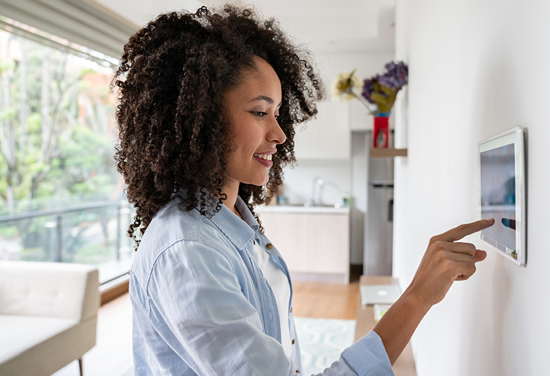 Person using home security touchscreen